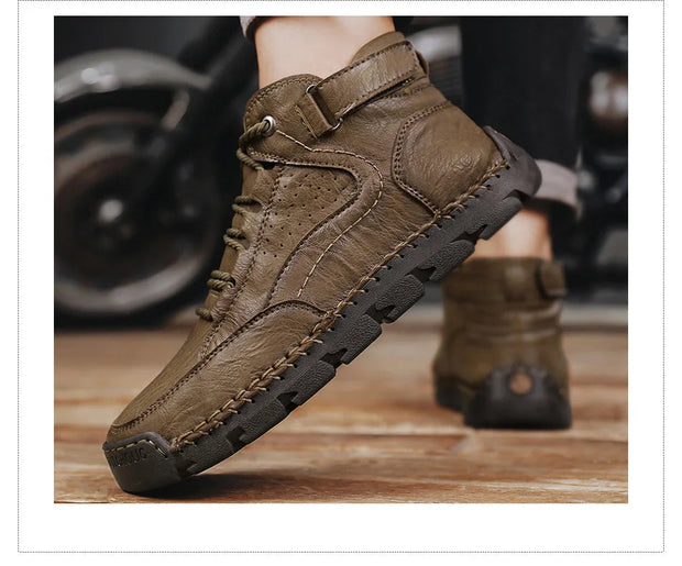 Brown leather boots with a buckle on a wooden floor.