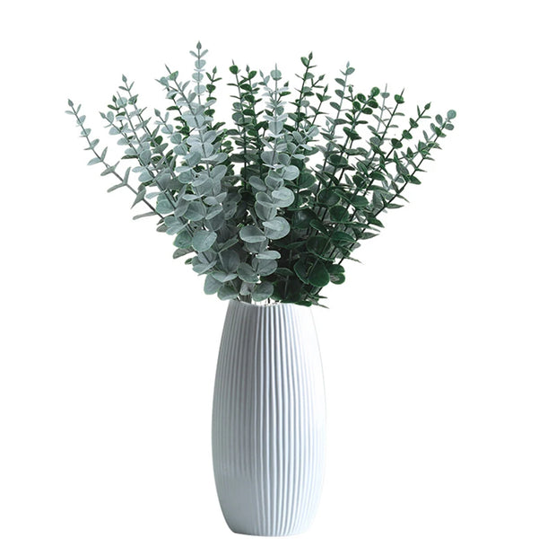 White vase with greenery on a white background
