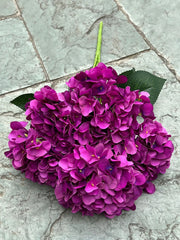 Bouquet of purple flowers on a stone surface