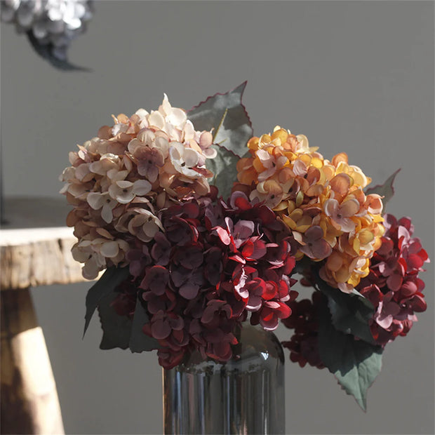Bouquet of multicolored flowers in a vase against a neutral background
