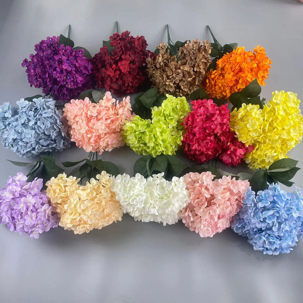 Assorted colorful flowers arranged in a circular pattern on a gray background