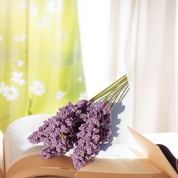 Purple flowers on an open book with a blurred background