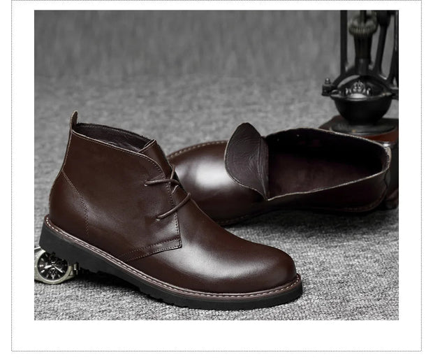 Brown leather boots on a textured surface with a sewing machine in the background