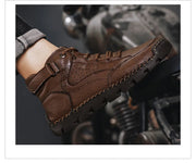Brown leather boot on a motorcycle with a blurred background