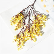 Decorative branch with yellow flowers on a white background
