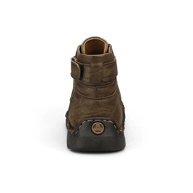 Brown leather boot with visible branding on a white background