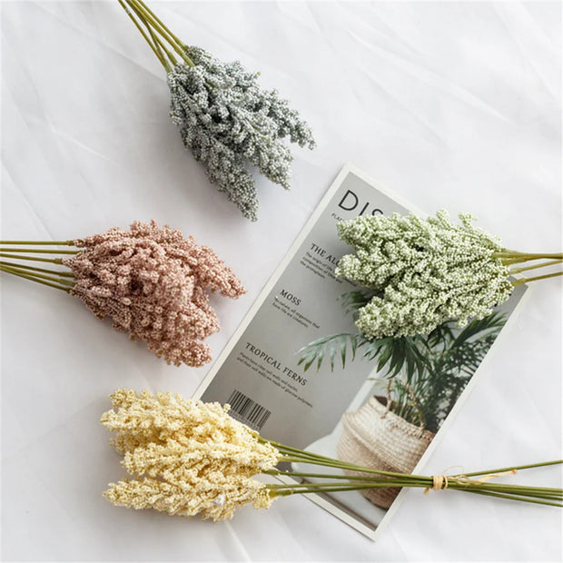 Four dried flower bouquets on a magazine with a white background