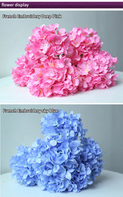 Two bouquets of flowers, one pink and one blue, on a white surface with a gray background.