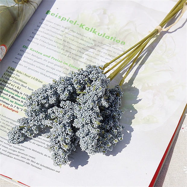 Bouquet of small flowers on an open book with text