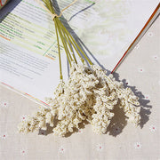Bouquet of white flowers on an open book with a floral patterned cover