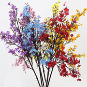 Colorful artificial flower branches on a white background