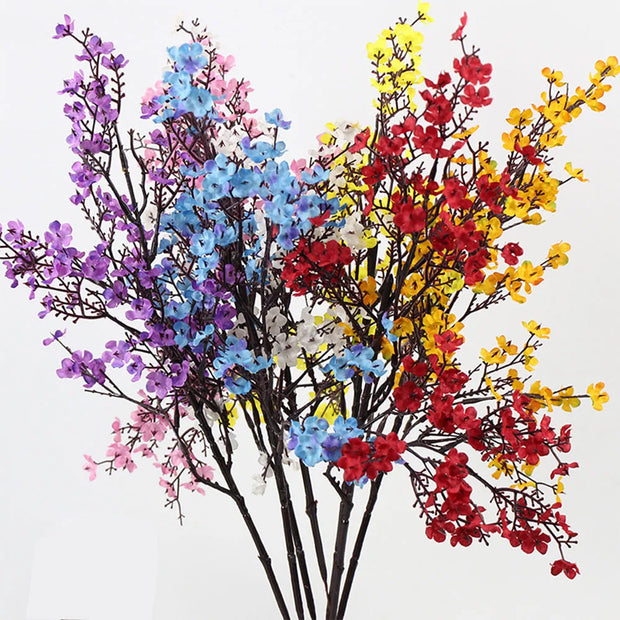 Colorful artificial flower branches on a white background