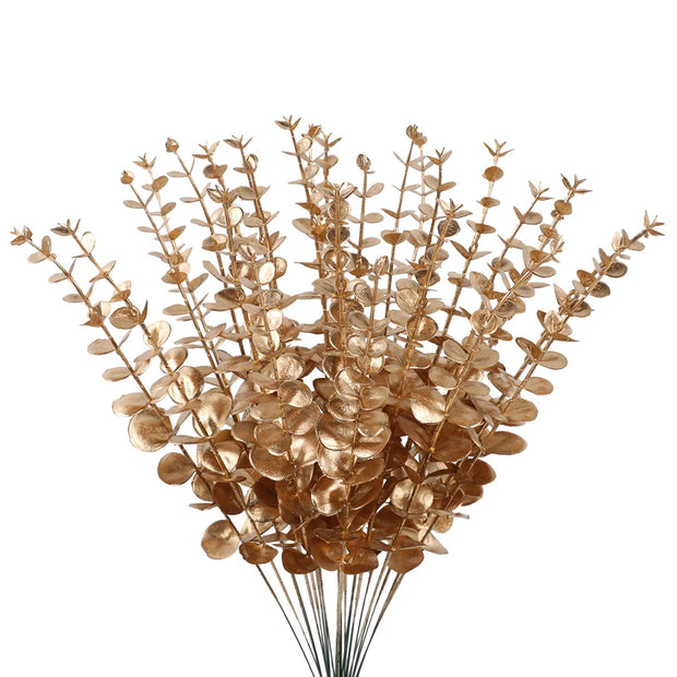 Bouquet of gold-colored artificial flowers on a white background