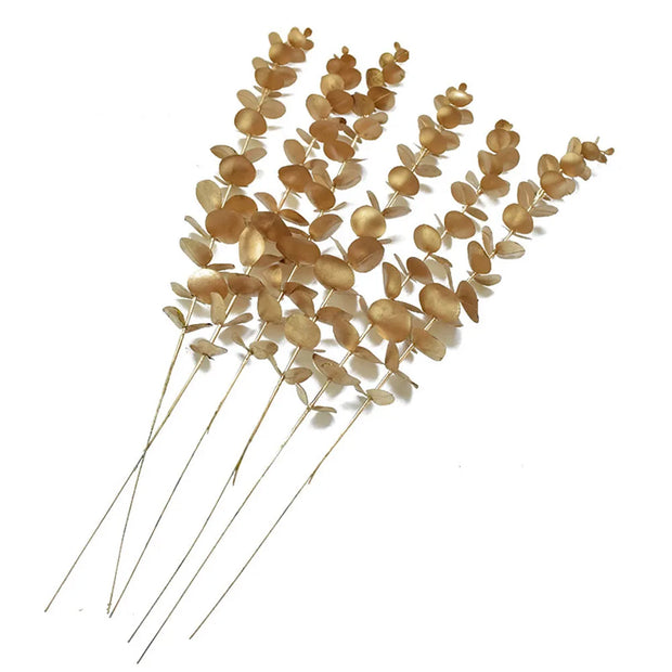 Set of dried eucalyptus branches with gold leaves on a white background