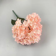 Pink artificial flower on a gray background