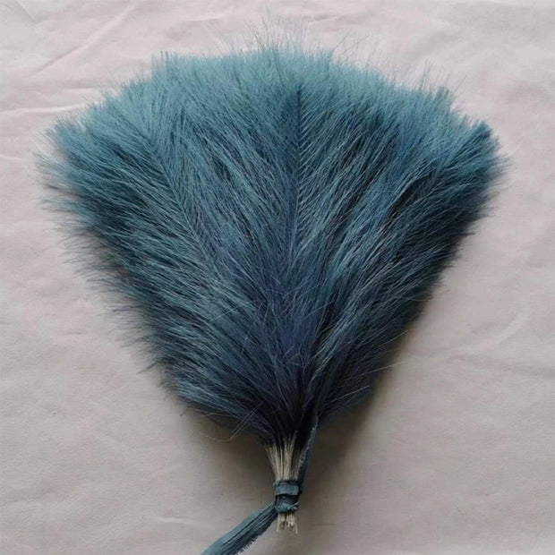 Blue feather fan on a light pink background