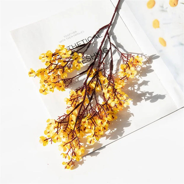Yellow dried flowers on a white surface with a polka dot pattern