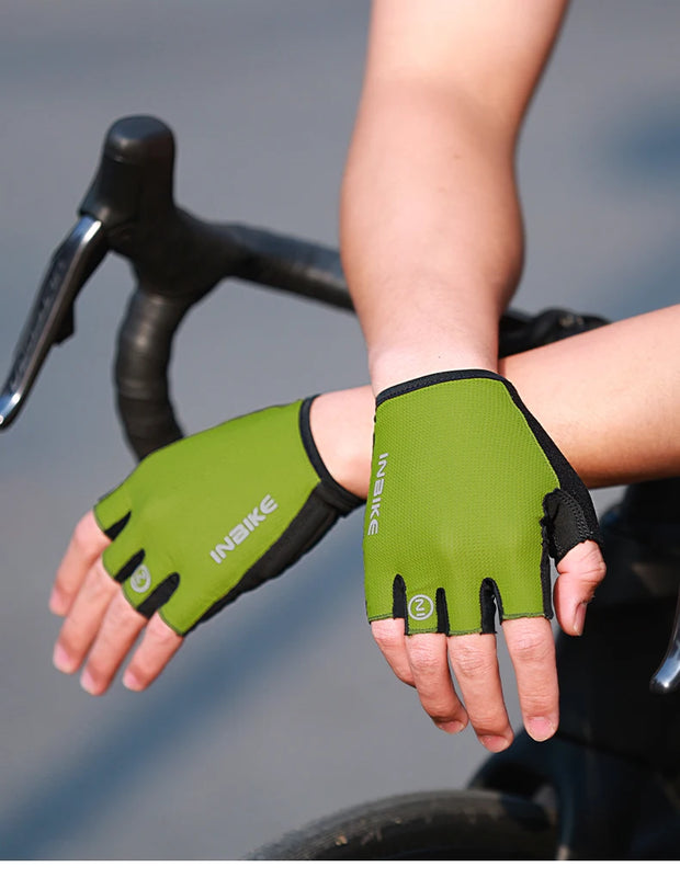 Green cycling gloves worn by a person on a blurred bike background