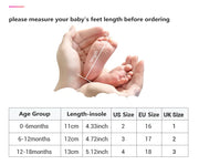 Measurement of baby feet with a chart showing size conversions.