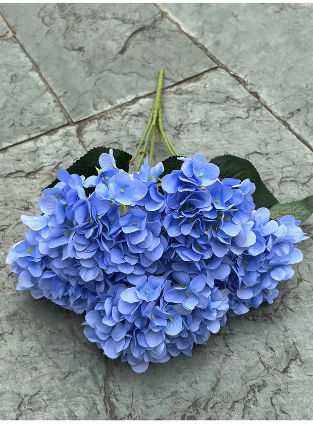 Bouquet of blue flowers on a stone surface