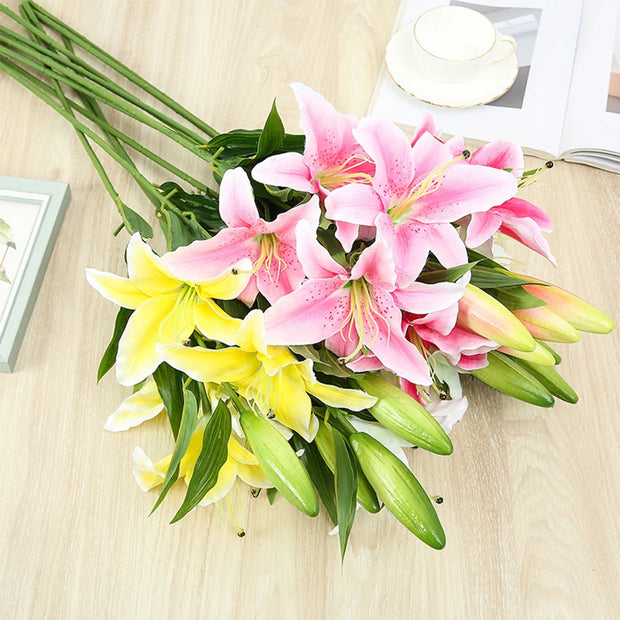 Bouquet of pink and yellow lilies on a wooden surface