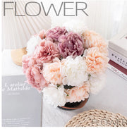 Bouquet of pink, white, and peach flowers in a pot on a surface with 'FLOWER' text.