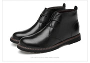 Pair of black leather boots on a white background