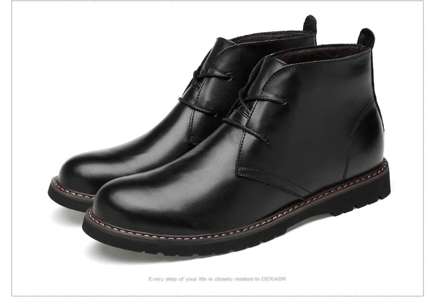 Pair of black leather boots on a white background