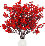 Bouquet of red artificial flowers in a white vase on a white background