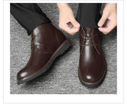 Brown leather shoes being worn on a gray textured surface