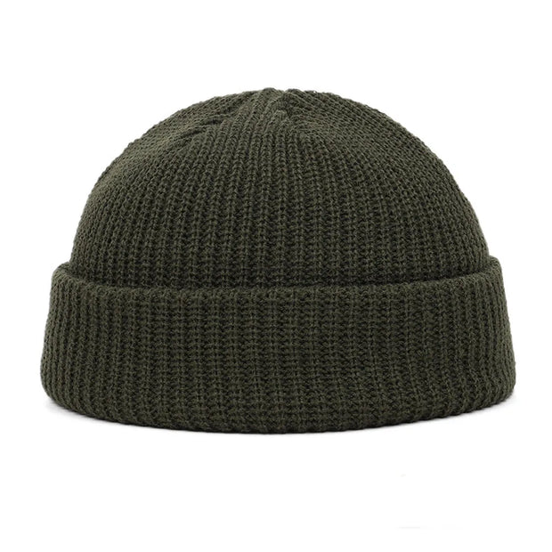 Green knit beanie on a white background