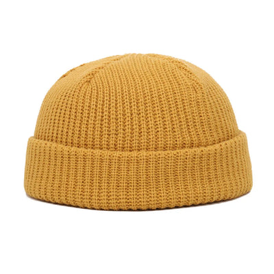 Yellow knit beanie on a white background