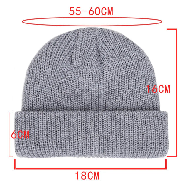 Gray knit beanie with measurements on a white background