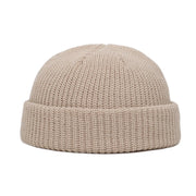 Beige knit beanie on a white background