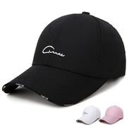 Black cap with white text on a white background, with additional caps in white and pink below.