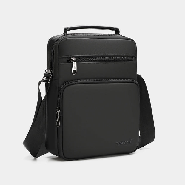 Black backpack with a shoulder strap on a light gray background