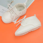 White sneakers on an orange surface with a book underneath