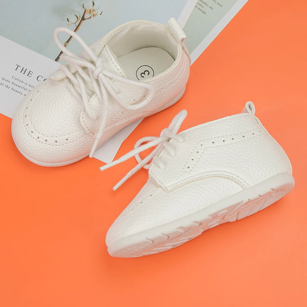 White sneakers on an orange surface with a book underneath