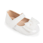White shoe with a bow on a white background