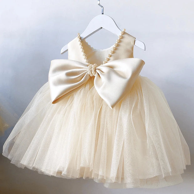 Beige dress with a large bow on a white background
