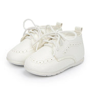 Pair of white baby shoes on a white background