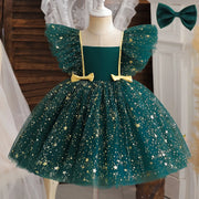 Green dress with star patterns on a mannequin, accompanied by a green bow.