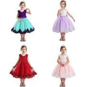 Four children wearing colorful dresses on a white background