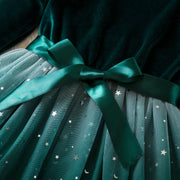 Teal dress with a bow and star pattern on a dark background