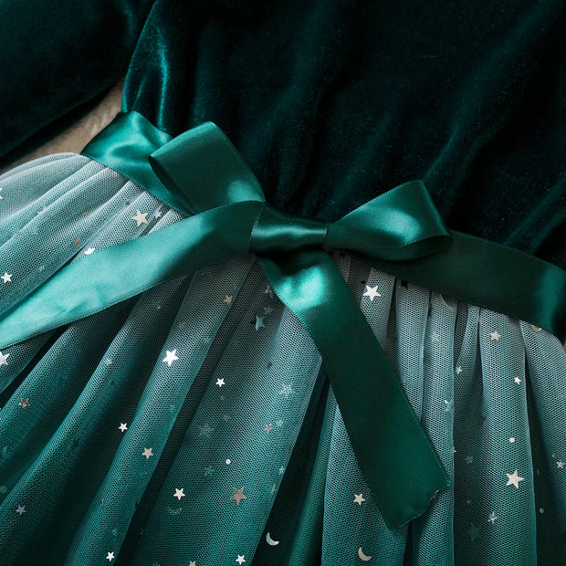 Teal dress with a bow and star pattern on a dark background