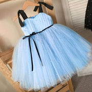 Light blue dress with black straps and belt on a wooden hanger.