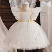 White dress with gold star patterns and yellow bows on a mannequin.