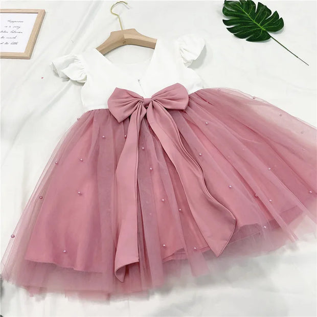 Pink tutu skirt with a bow on a white background