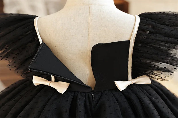 Black dress with white bows on a mannequin