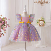 Children's dress with star pattern on a mannequin in a decorative room.